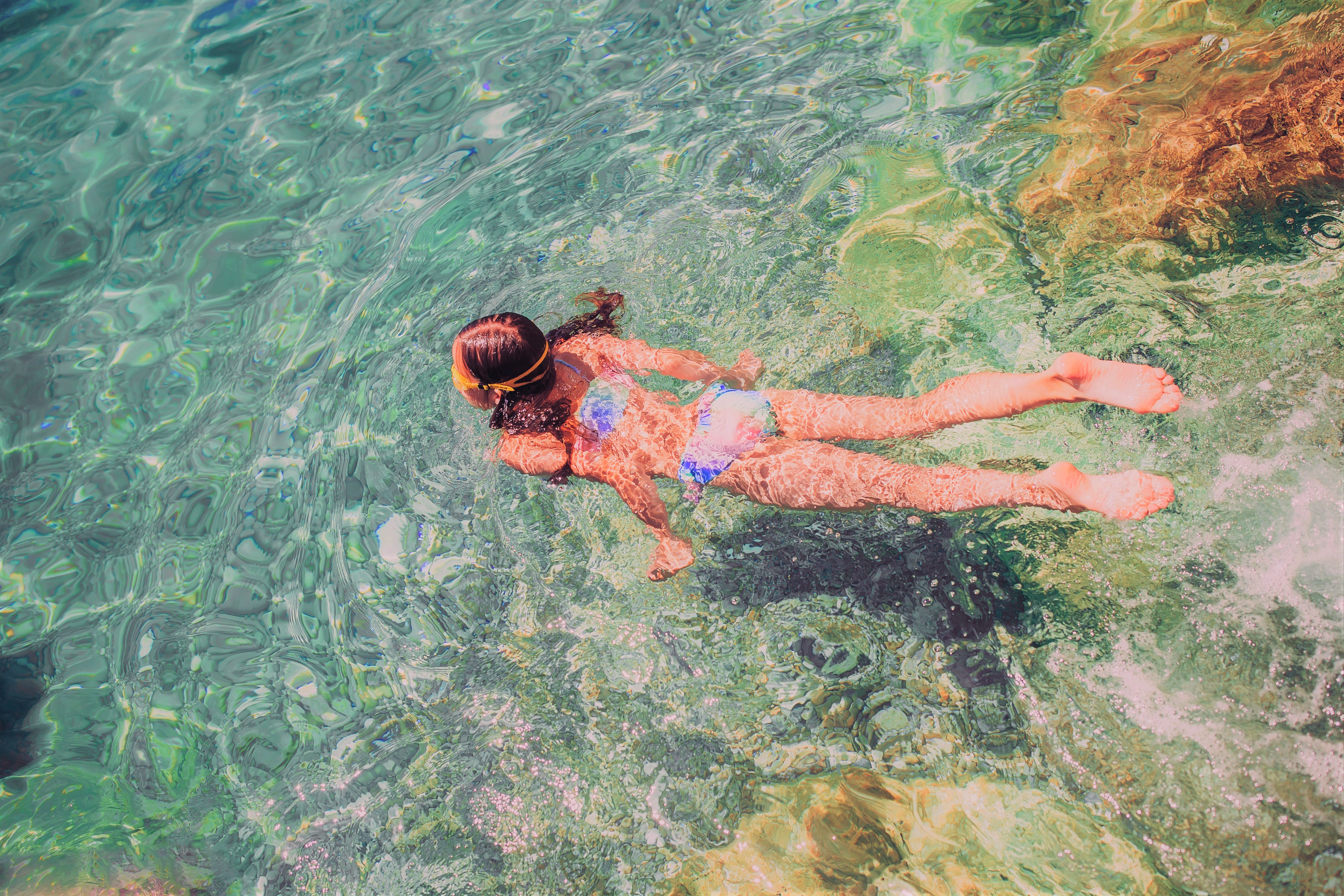 Girl Swimming in Clear Ocean