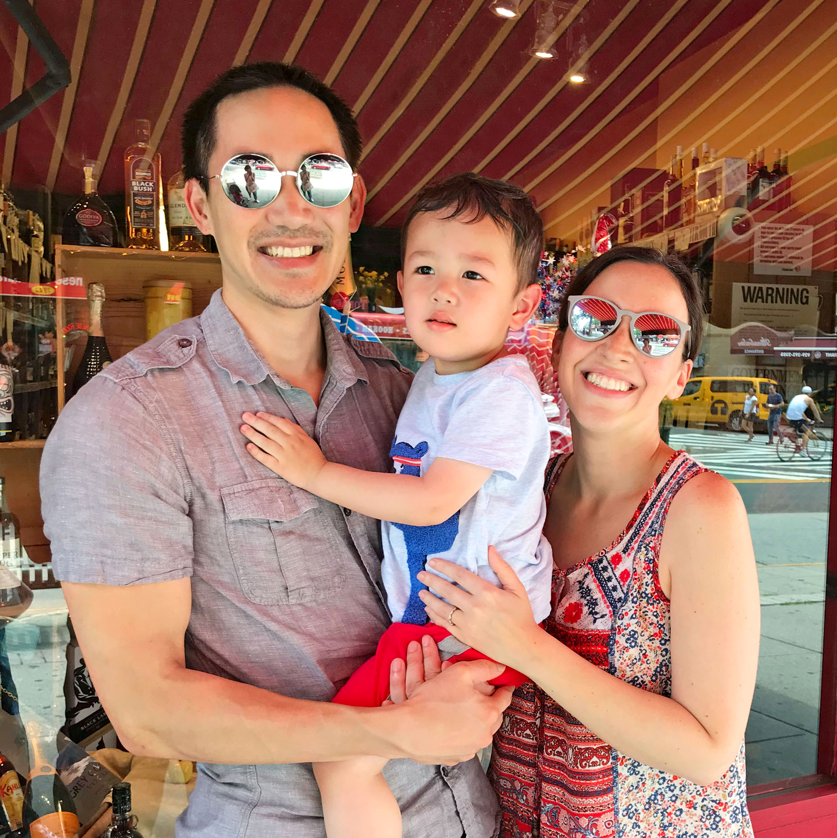 young family outside storefront